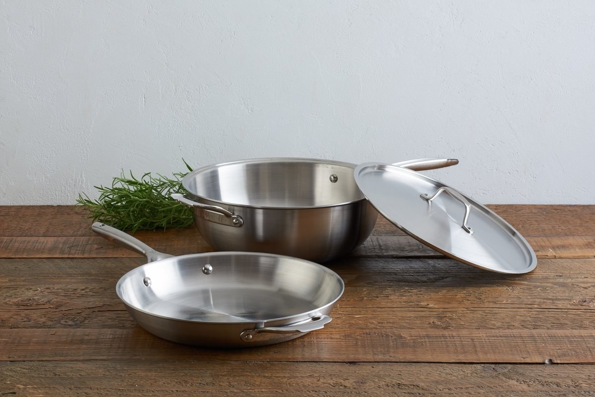 The stainless steel skillet, pot, and lid on a counter