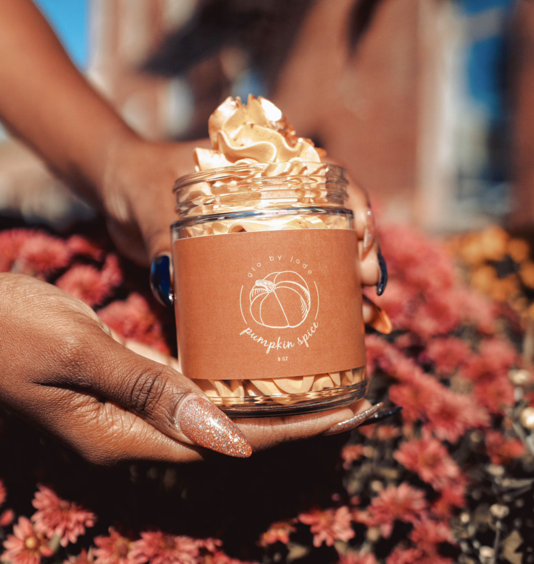 manicured hand holds jar of the pumpkin spice whipped body butter