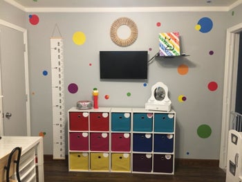 Reviewer's photo showing the canvas growth chart in their kid's play space