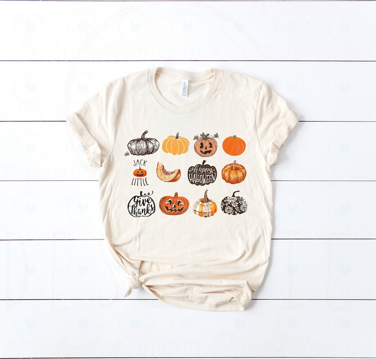 The white T-shirt with 12 different styles of pumpkins printed on it in a grid format