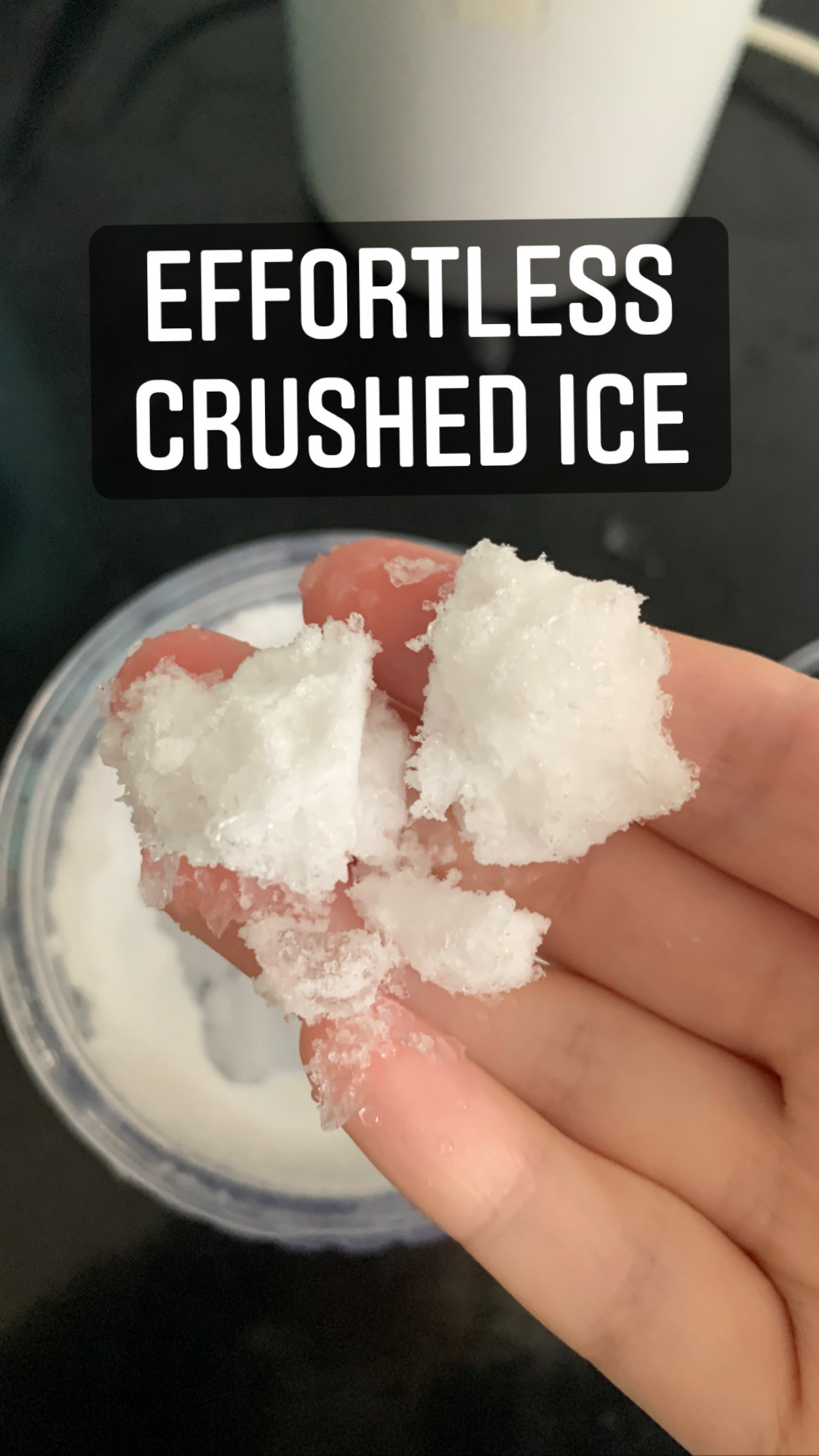My hand holding a couple of tablespoons of crushed ice