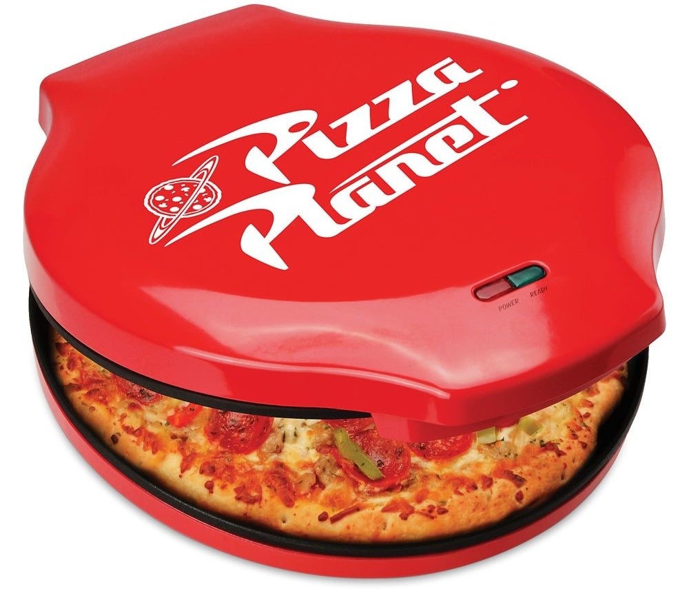 the round red pizza maker with a Pizza Planet logo on top