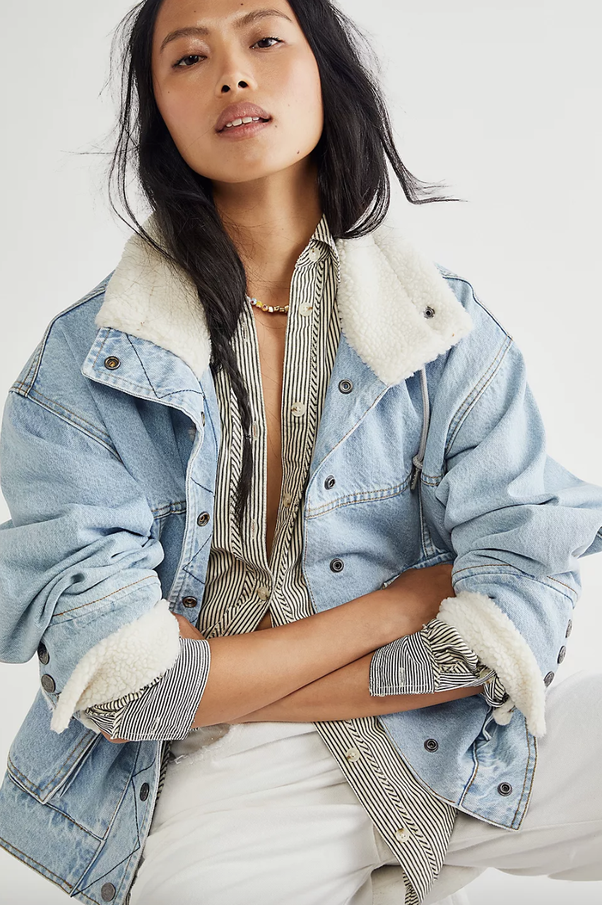 model wearing denim bomber jacket