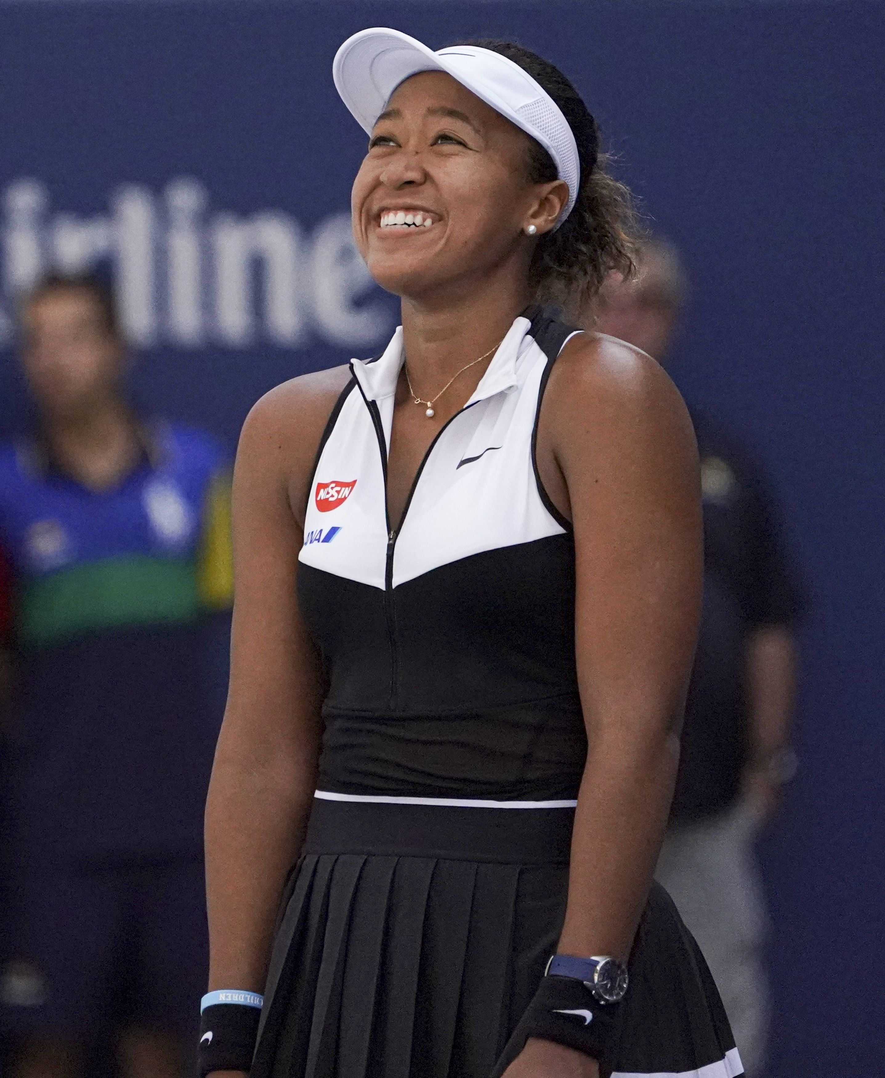 Naomi smiling on the tennis court
