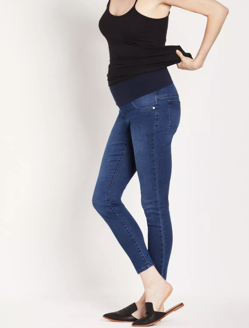 A model wearing maternity jeans