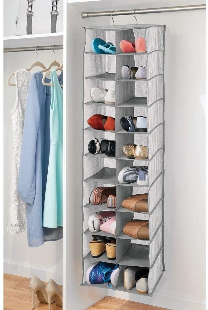A large hanging shoe organizer in a neat closet