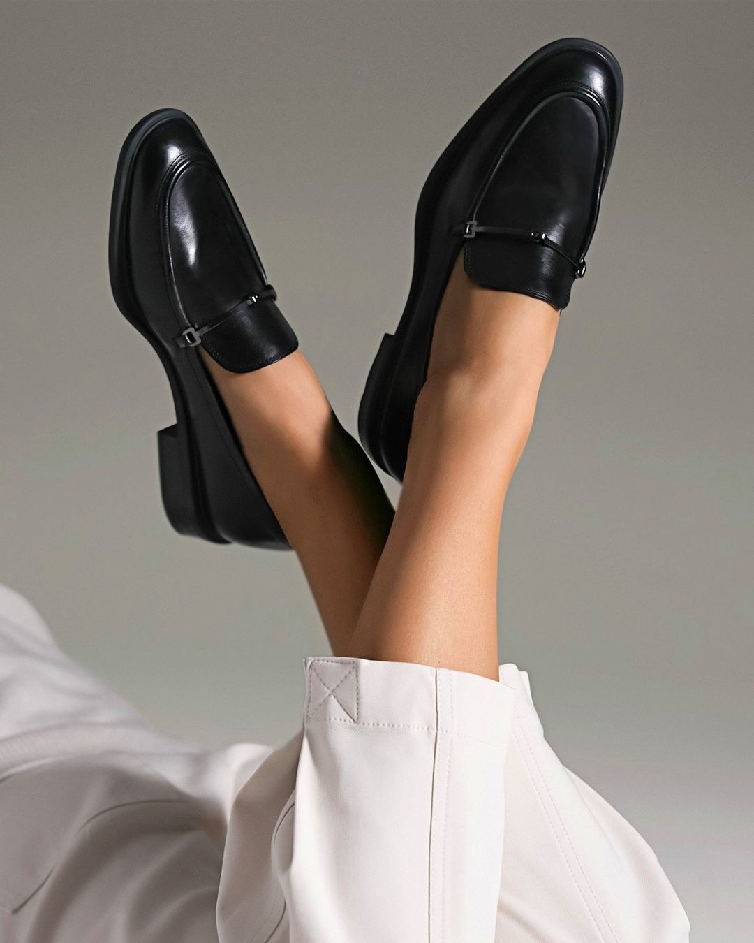 model wearing the black loafers