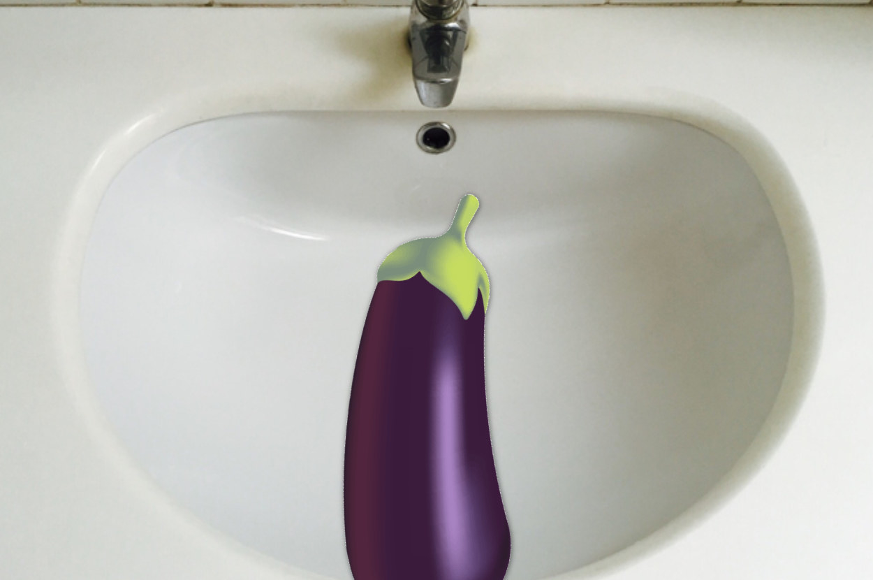 eggplant emoji over a sink