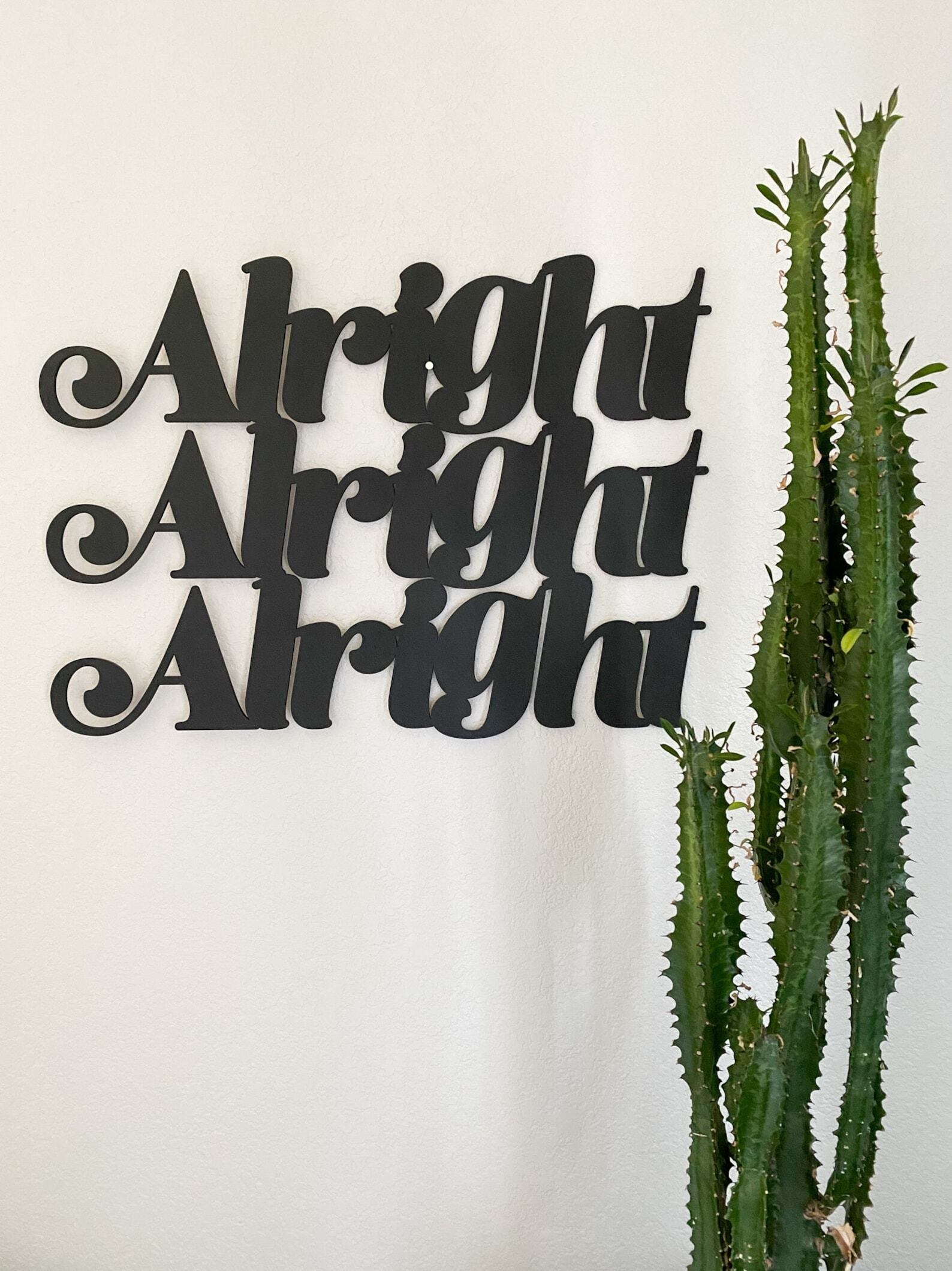 woodcut sign in retro text that says alright alright alright