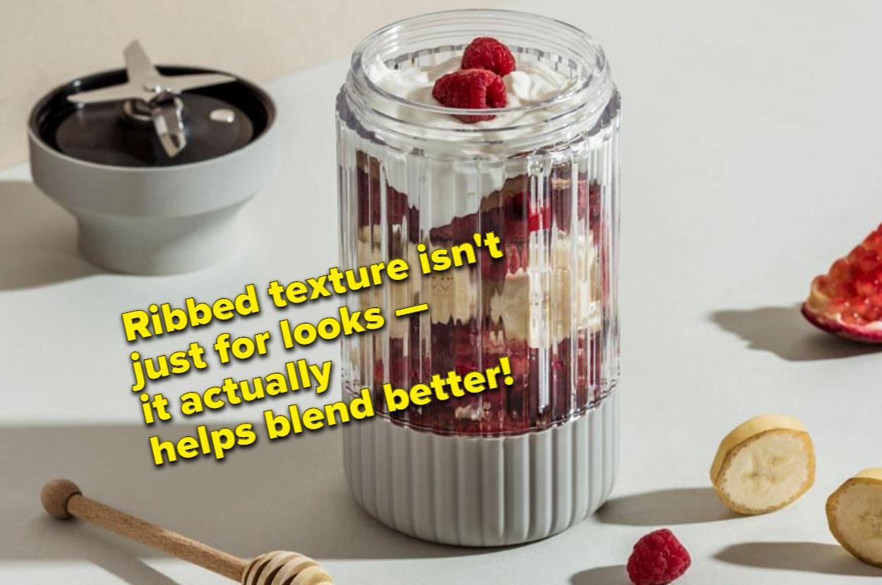 The blender jar filled with berries, yogurt, and other fruit