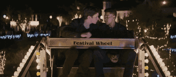 Simon kissing Bram at the top of the ferris wheel