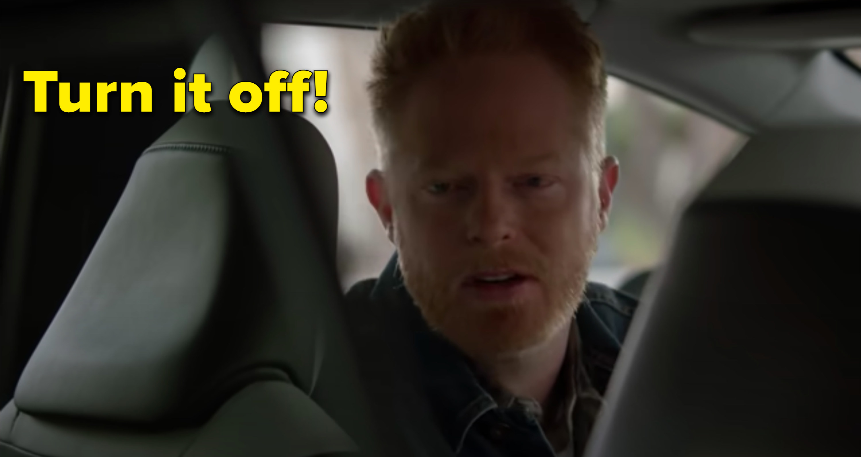 Mitchell from Modern Family looking at back of car annoyed with caption &quot;Turn it off!&quot;