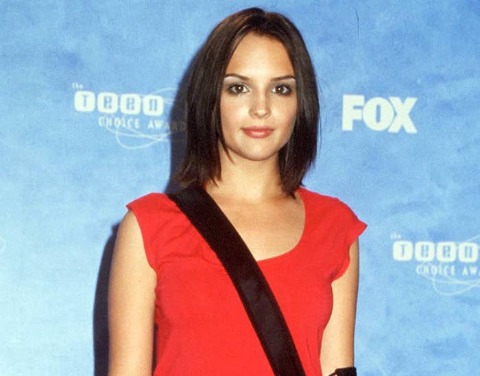 A young Rachael attends an event in a red t-shirt with a black messenger bag