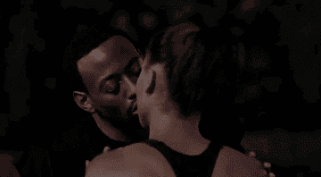 Q kissing Monica on the basketball court after their game