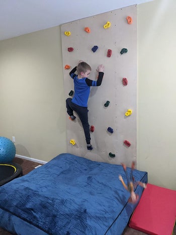 Reviewer's photo showing their child on the rock climbing wall