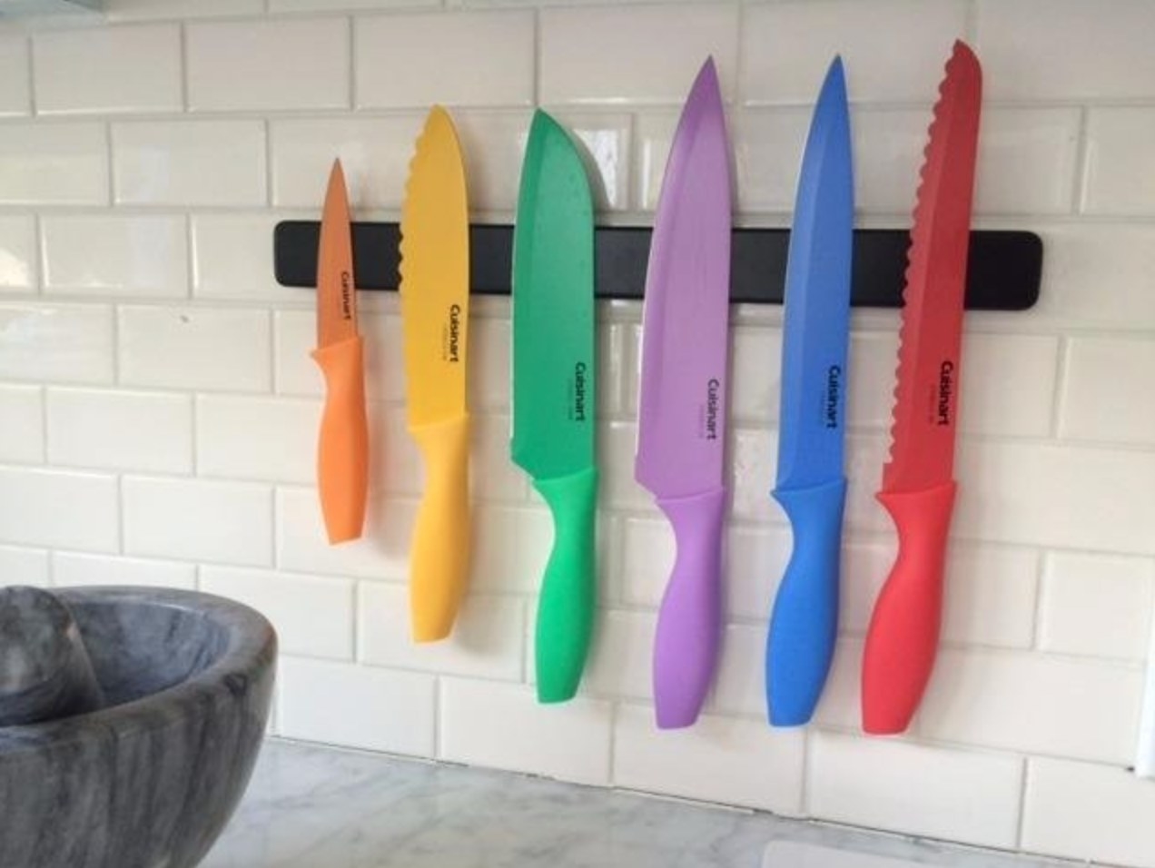 the Cuisinart 12 piece knife set on a reviewer&#x27;s magnetic wall hanging