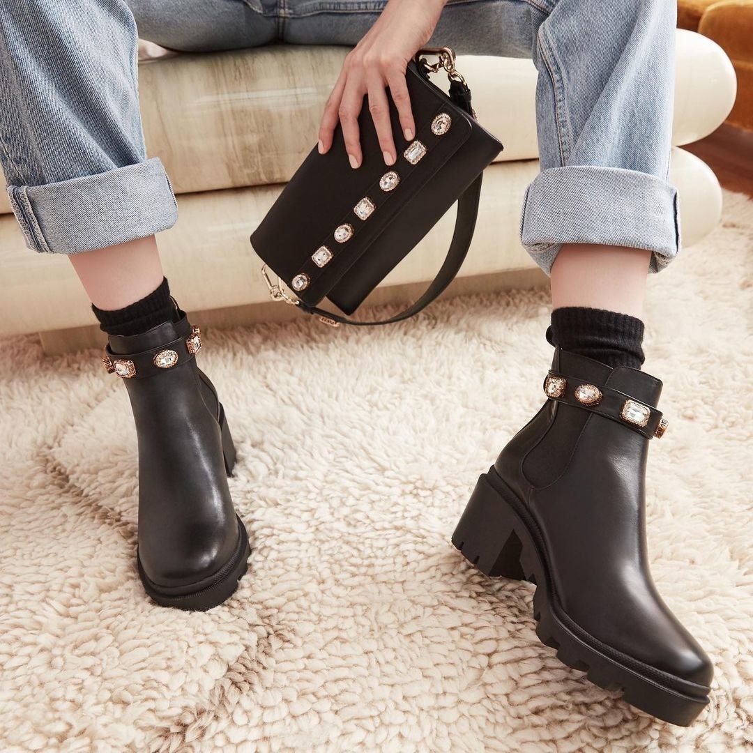model wearing the chunky black boots with jewels around the ankle