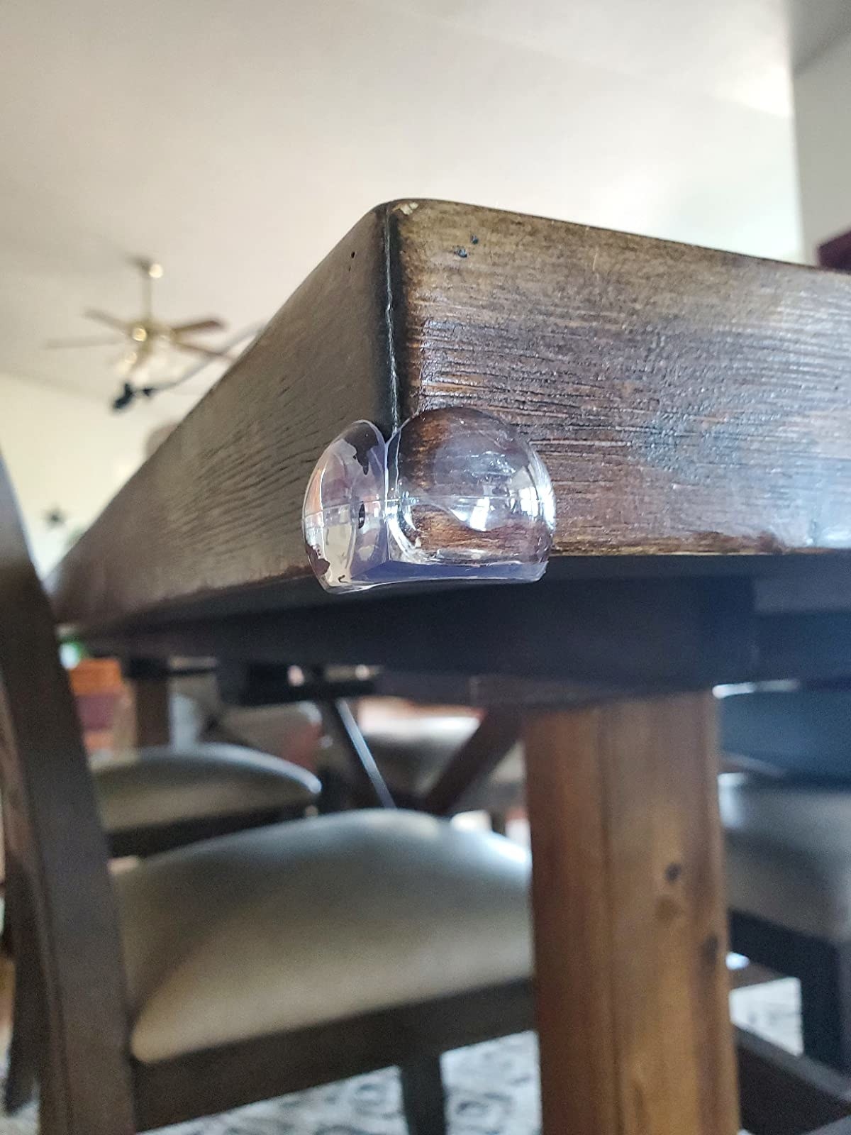 reviewer image of a corner protector on the corner of a wooden table