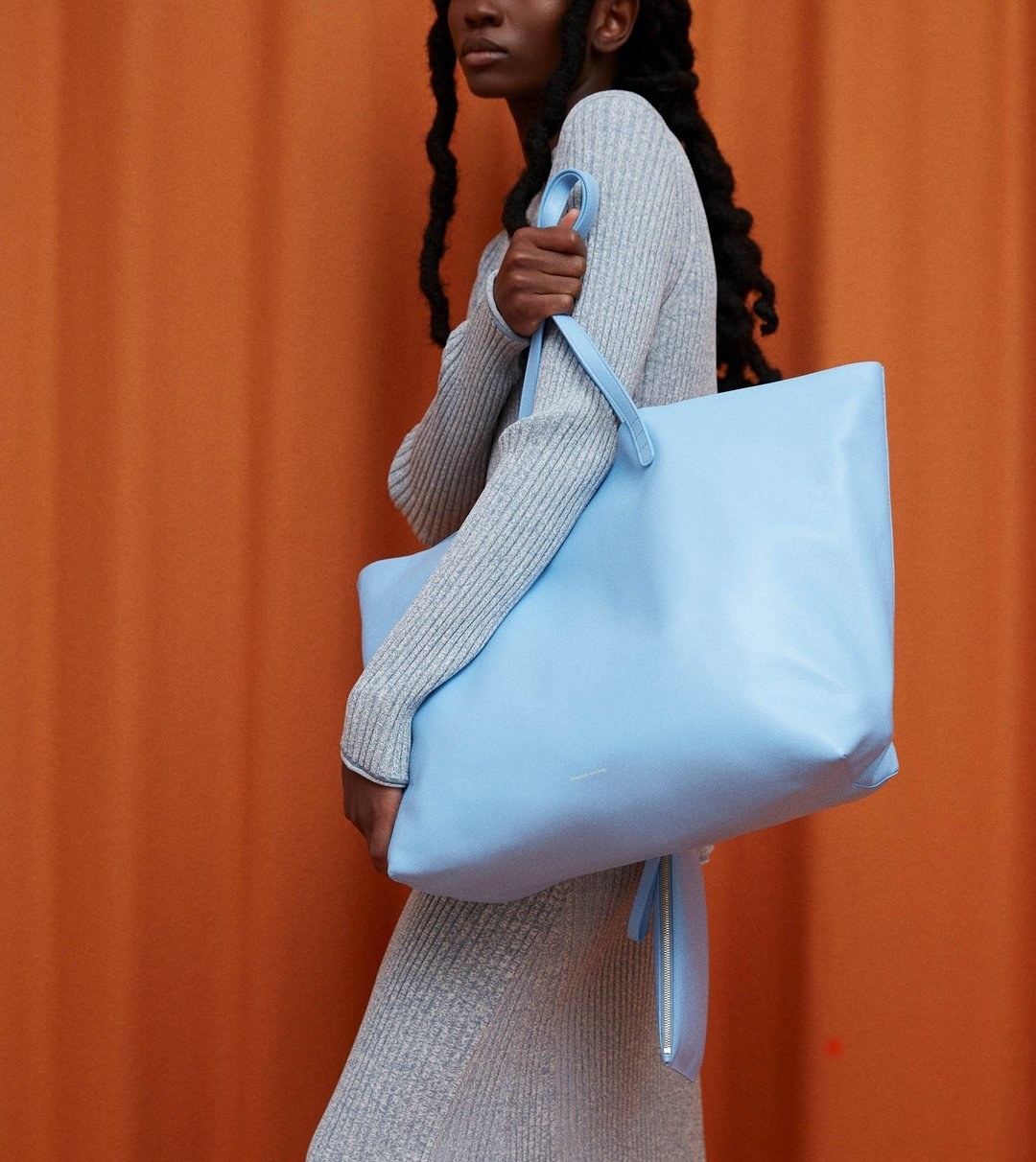 model holding the blue tote