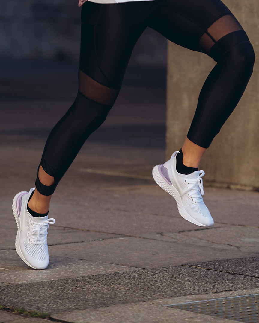 model wearing white running shoes