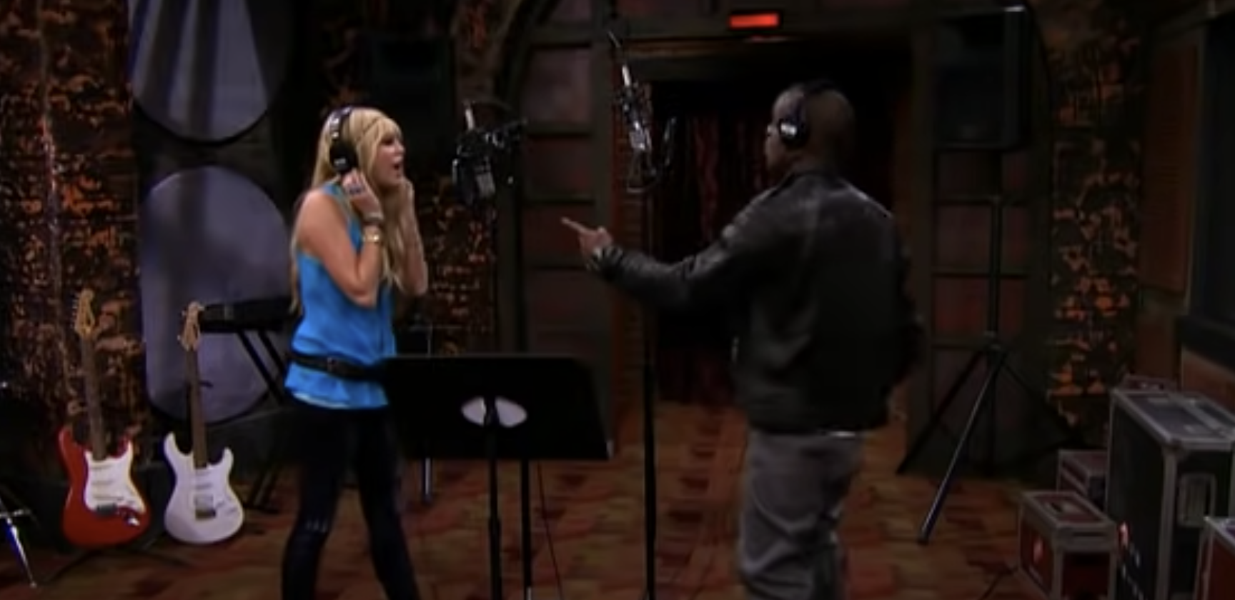 Hannah Montana and Iyaz are singing together in a recording studio