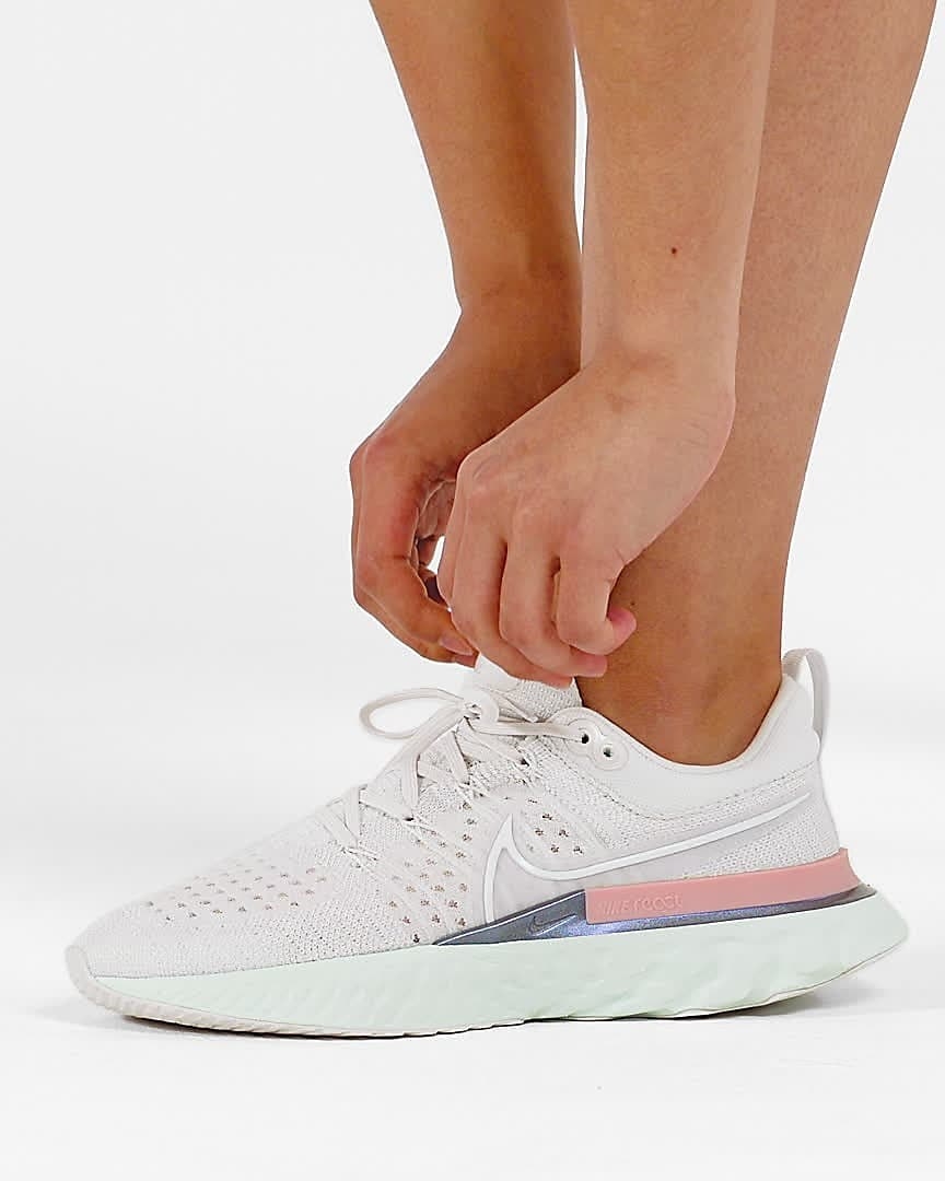 model wearing white and pink Nike React Infinity Run Flyknit 2 sneaker