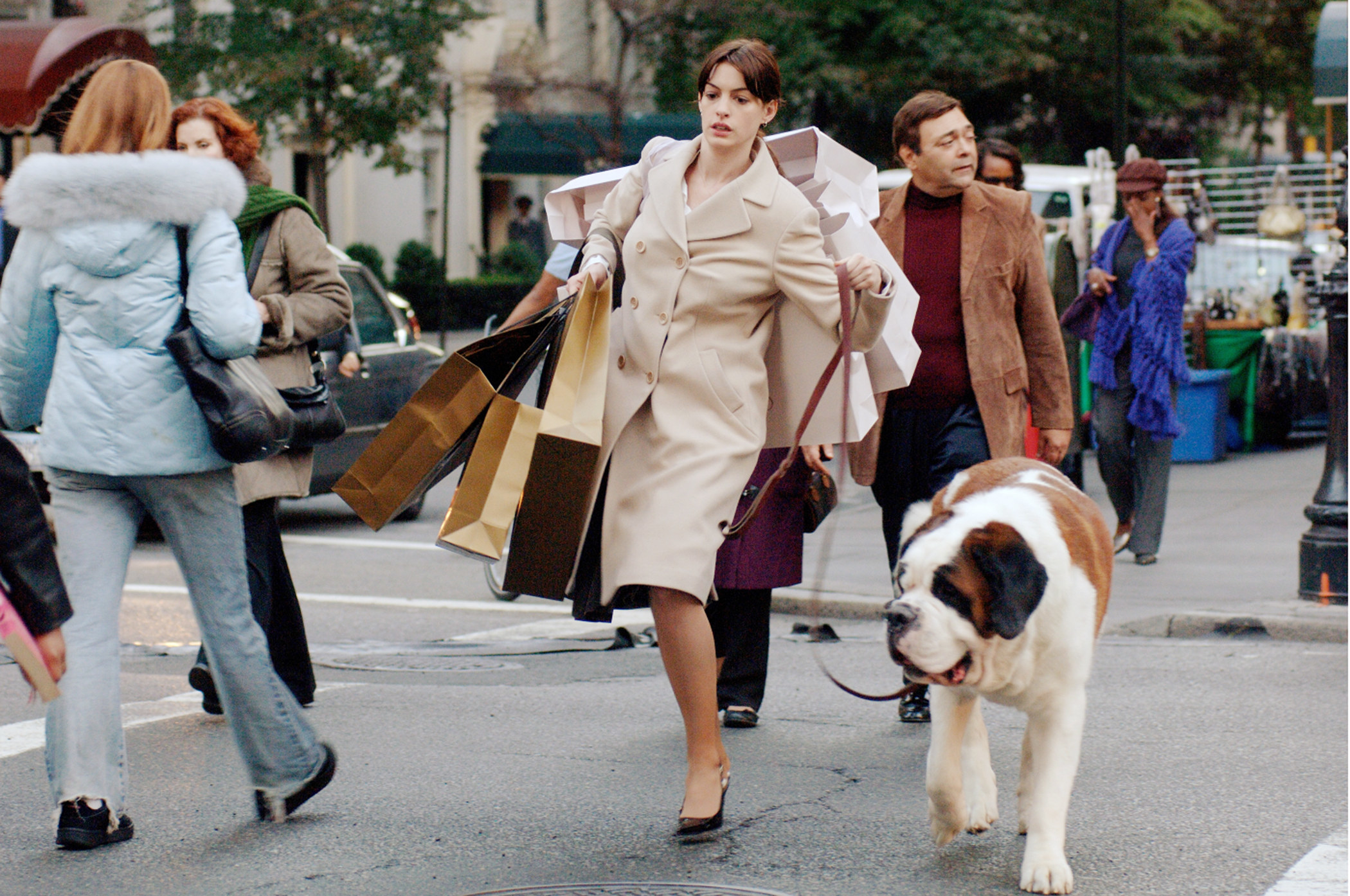 Anne Hathaway wearing heels while walking a dog and carrying a bunch of shopping bags in &quot;The Devil Wears Prada&quot;