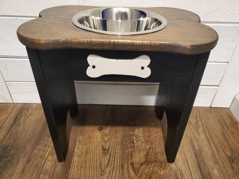 elevated dog bowl with a wooden top and a black stand