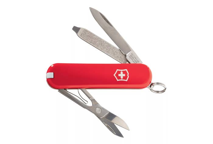 red swiss army knife with all the attachments out