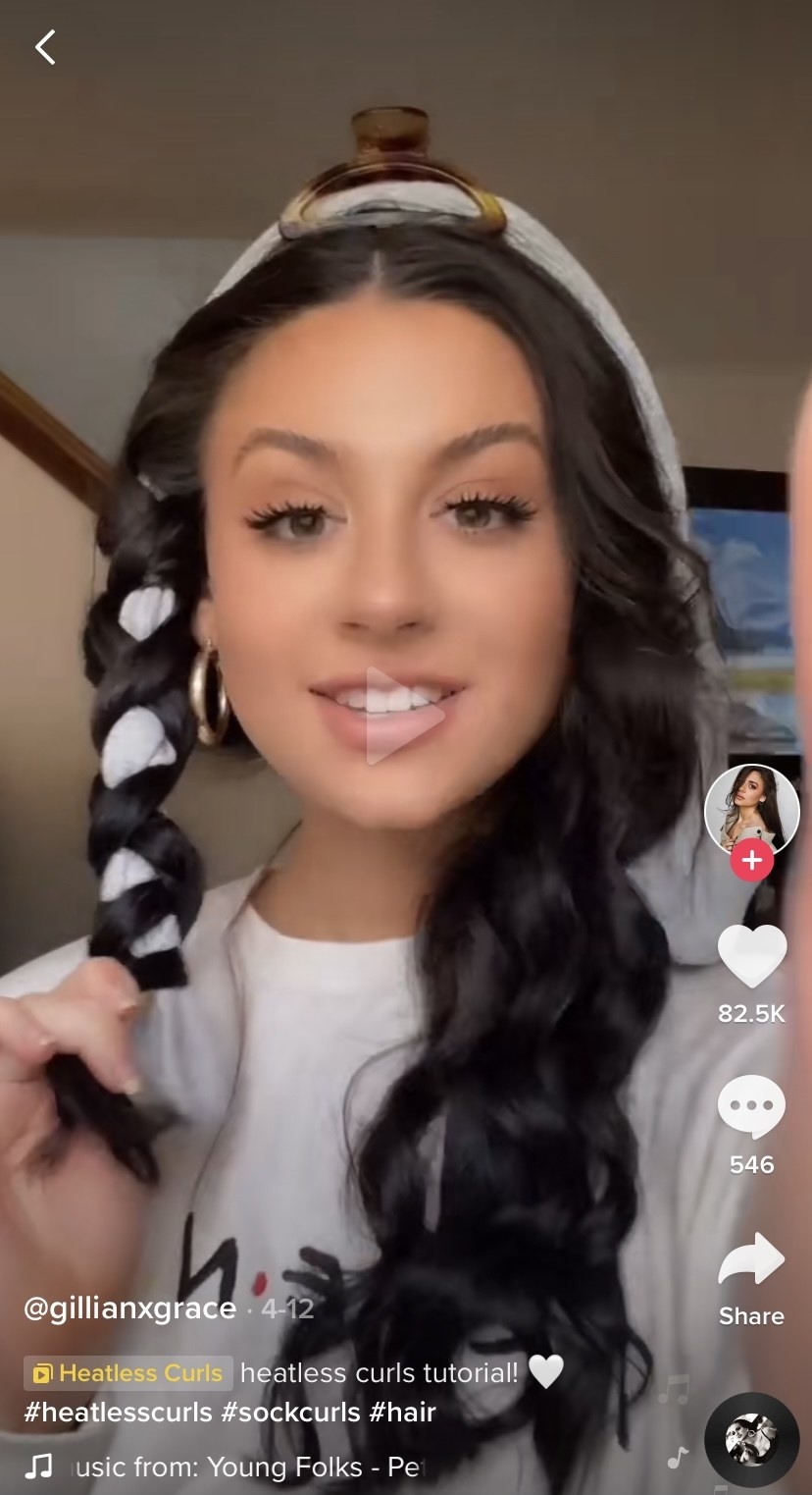 A woman on TikTok demonstrates a no-heat curl technique