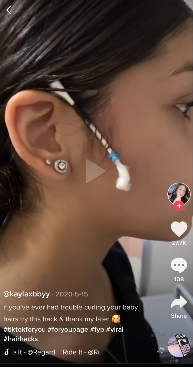 A woman on TikTok curling her baby hairs with Q-tip