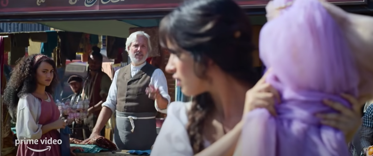 Cinderella at a market hoping to sell her dress creation