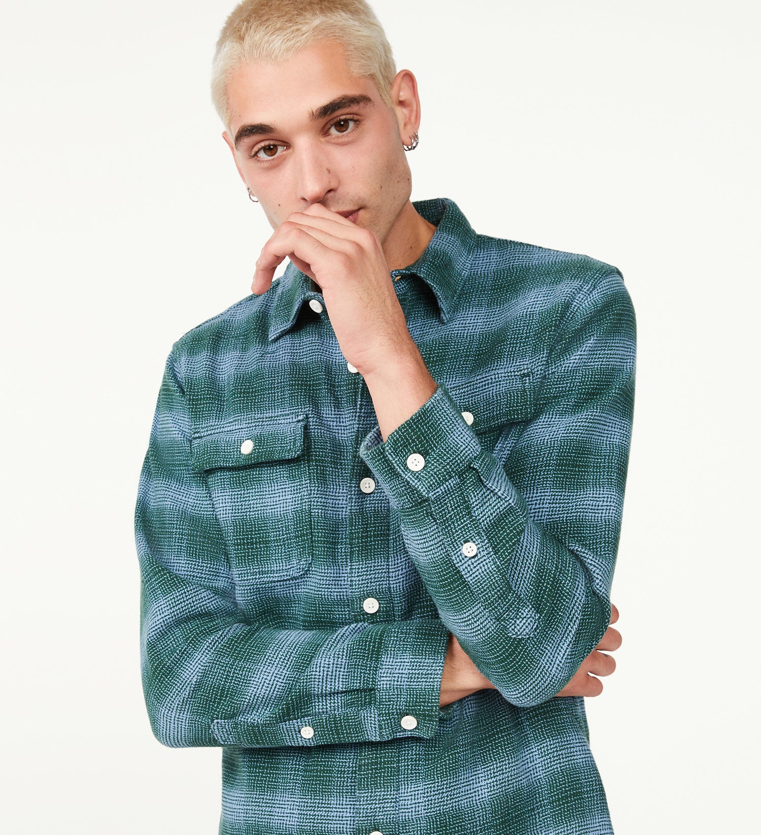 model wearing long-sleeve button down flannel in grey/blue plaid