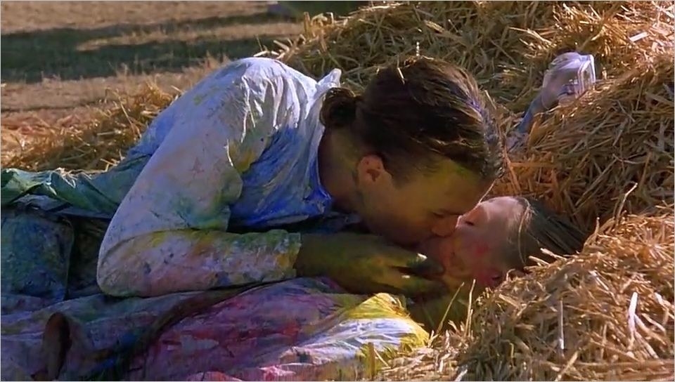 Patrick kissing Kat in a bale of hay