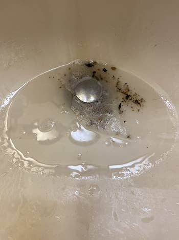 on right, same sink with black gunk coming out of drain  after using the cleaner above