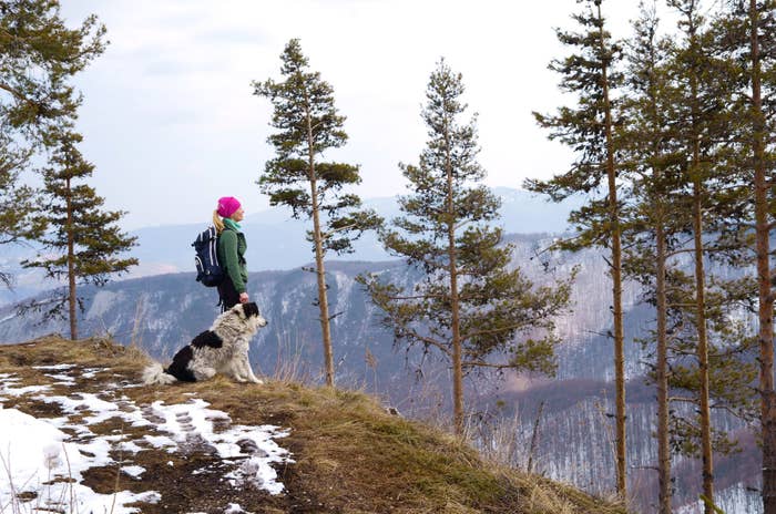 Woman on a hike with her dog.