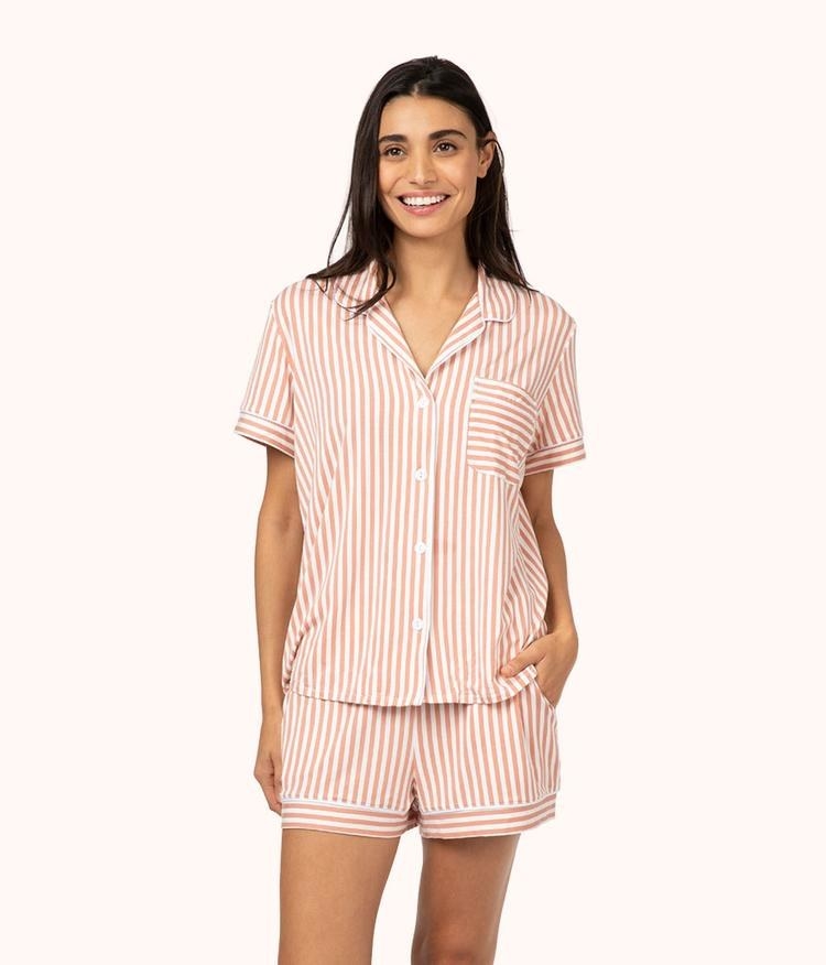 model in the pink and white stripe short sleeve button down and shorts set