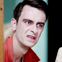 Rudy from Misfits pulls a face and closes a door as he backs out of it