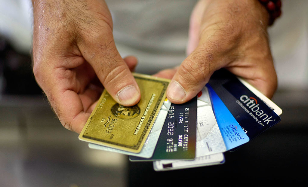 Man holding out credit cards