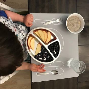 Reviewer's photo of the grey silicone mat with marking to guide children to set the table