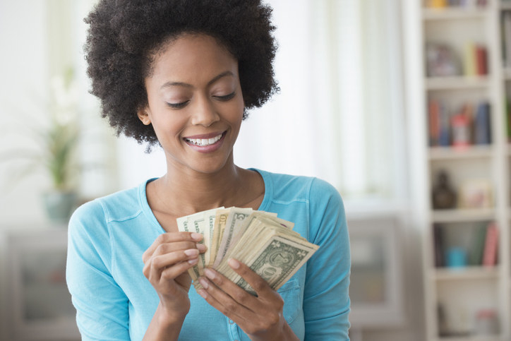 Woman holding a stack of cash