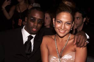 Diddy puts his arm around Jennifer while sitting at an award show