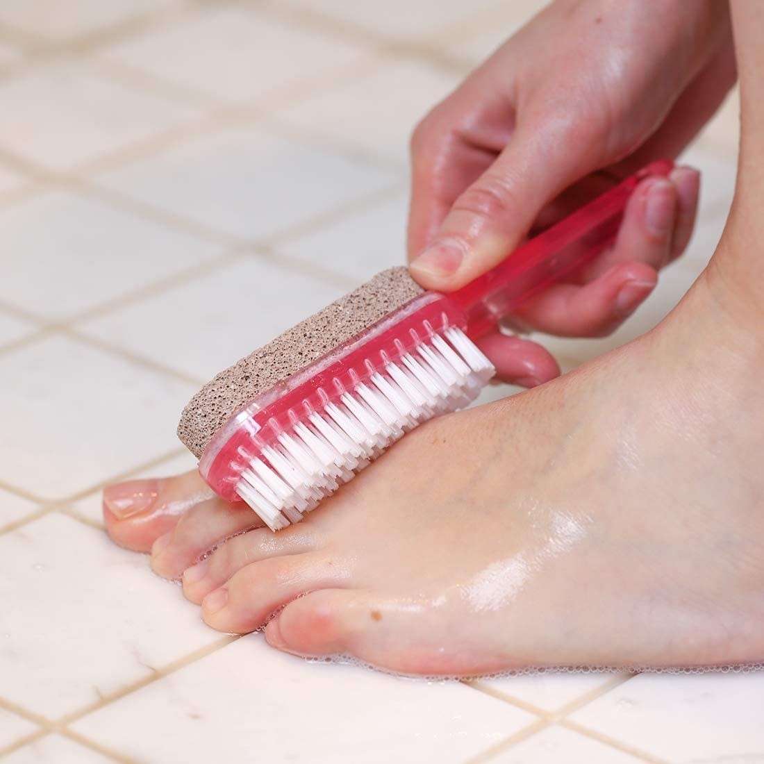 A person scrubbing their foot in the shower