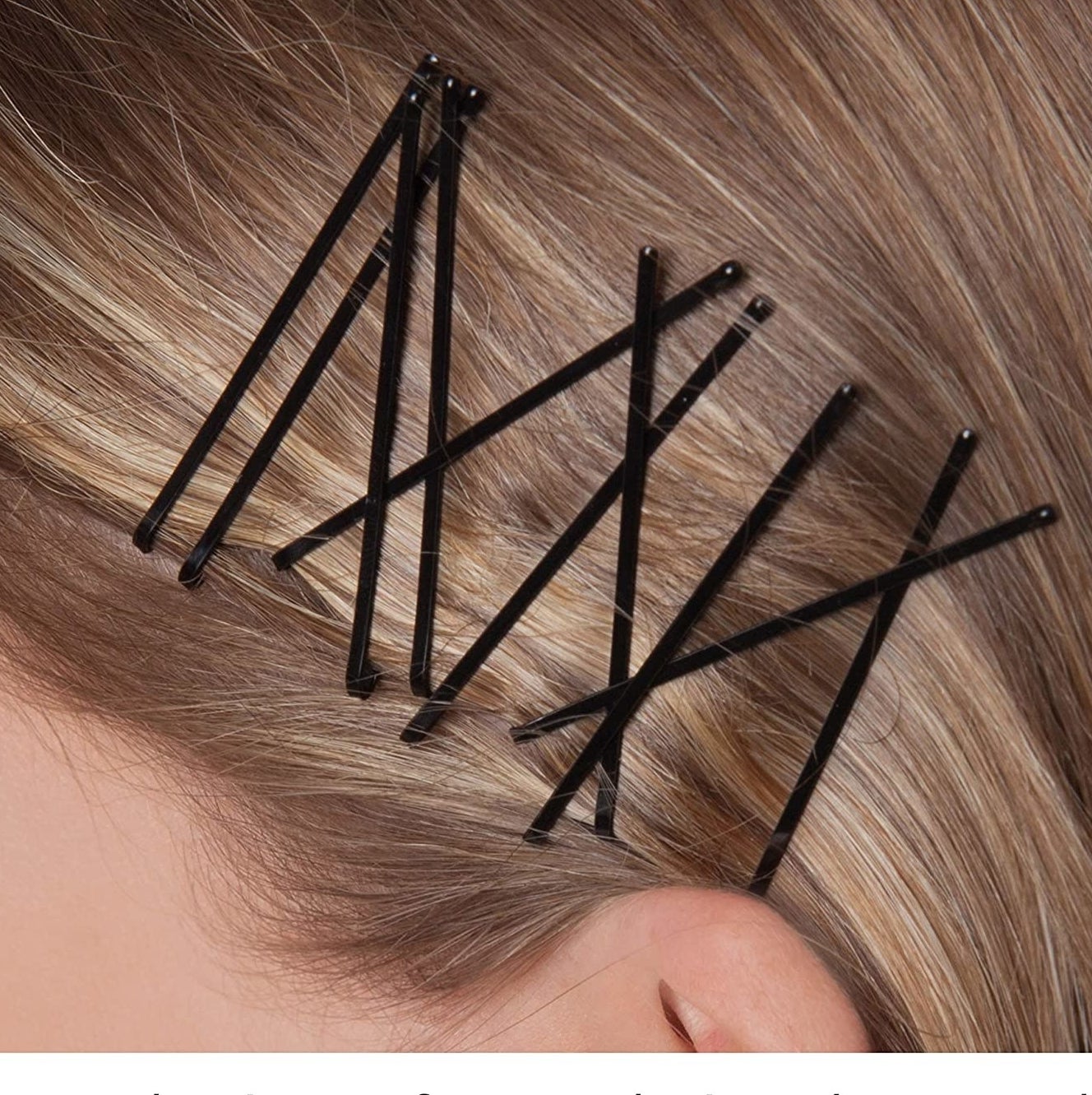 A person with several bobby pins in their hair