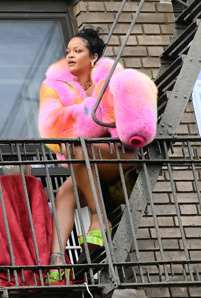 Rihanna is pictured on a fire escape in the Bronx while filming a music video in July of 2021