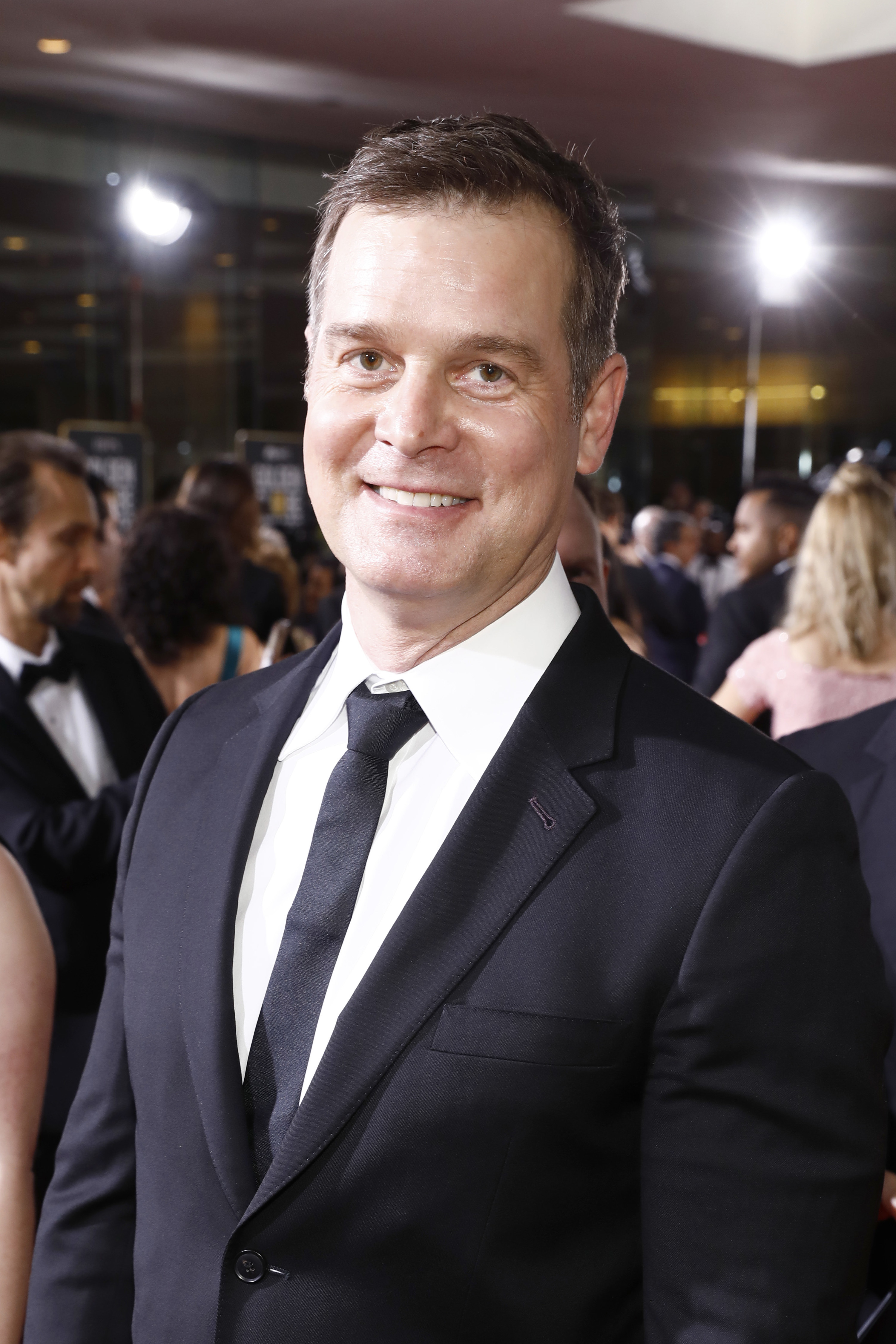 Peter in a suit at a red carpet event