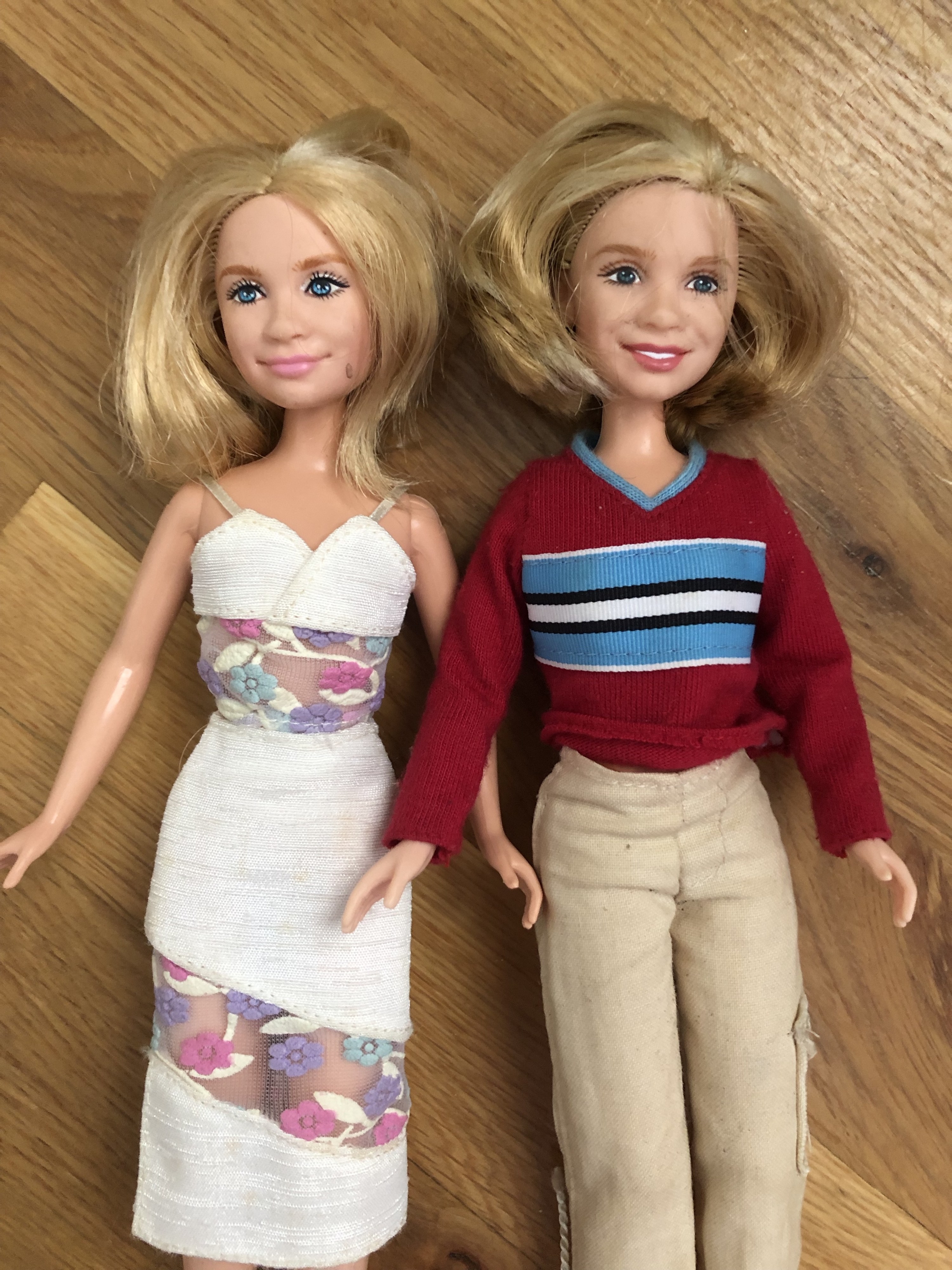 Mary-Kate and Ashley dolls laying next to each other, hair frizzy
