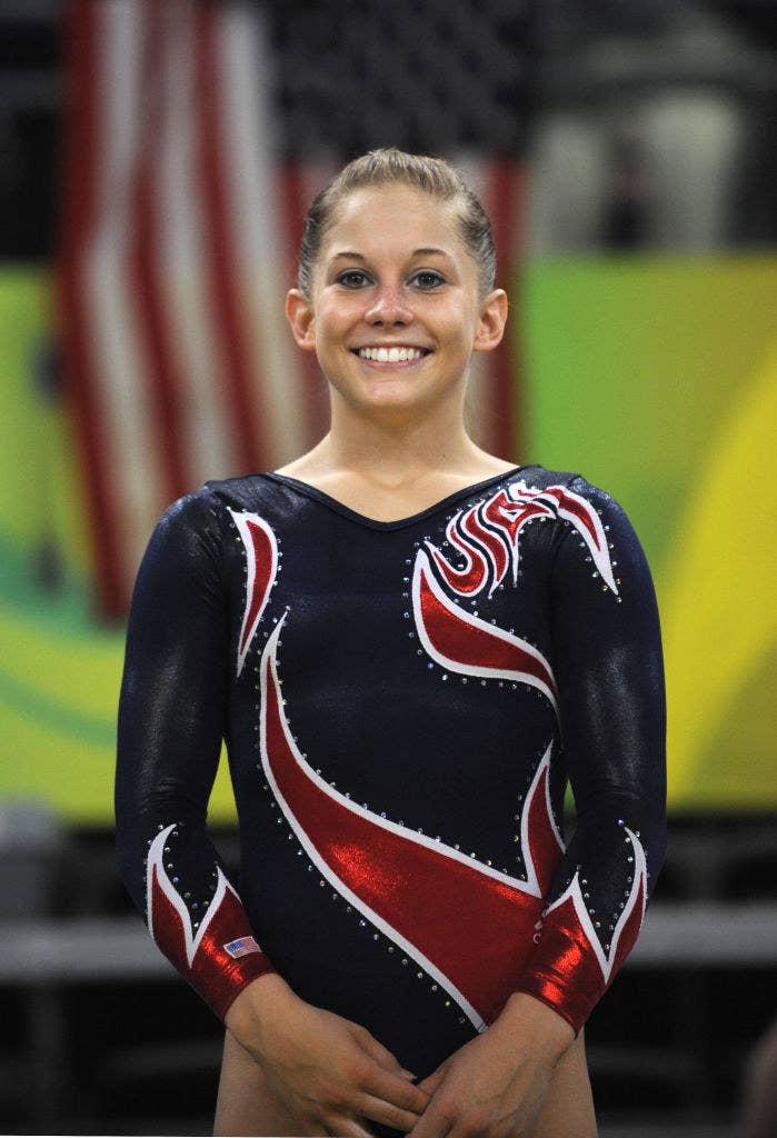 Shawn smiling as she stands in her leotard