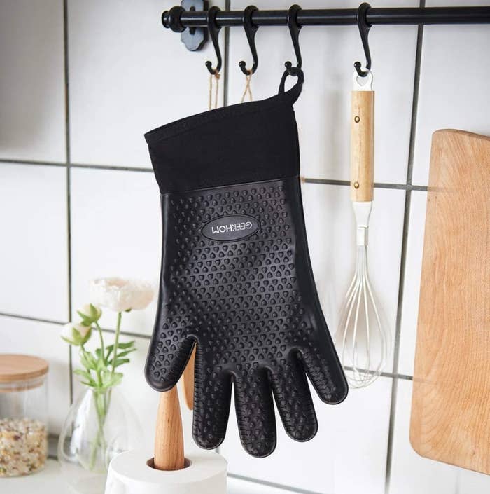 A glove hanging from a hook in a kitchen
