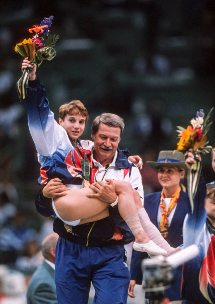 An injured Kerri being carried by Bela Karolyi after the medal ceremony